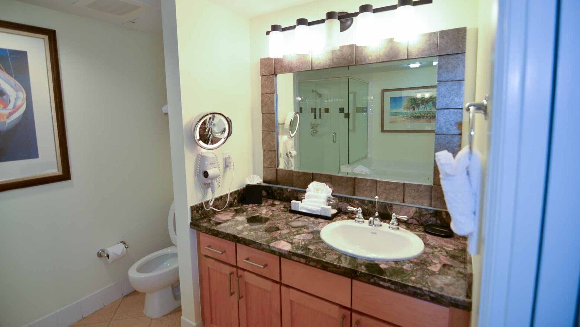 A bathroom with a sink, mirror, and toilet.