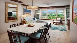A dining area with a marble table, chairs, and a view of the outdoors.