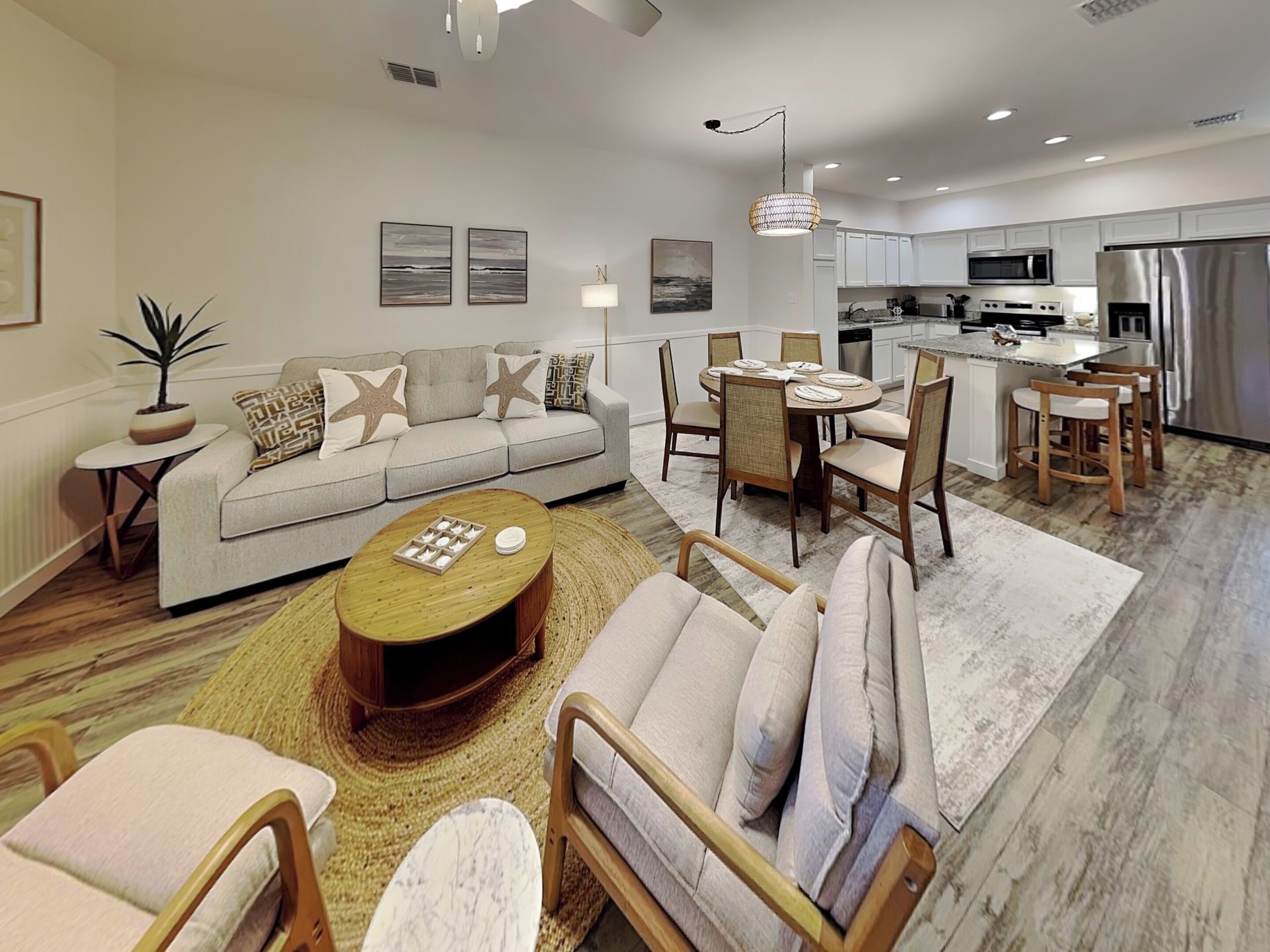 A modern living room with a sofa, coffee table, and dining area.