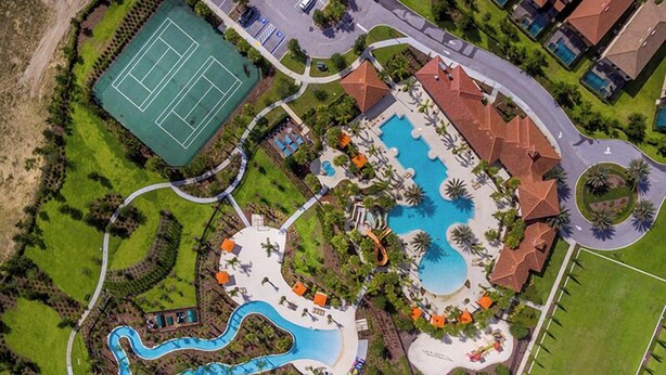 An aerial view of a resort with a swimming pool, tennis court, and landscaped areas. - Solterra Escape | 14 Bdr, Game Room, Lego Playroom, Theater, Private Pool (Davenport)