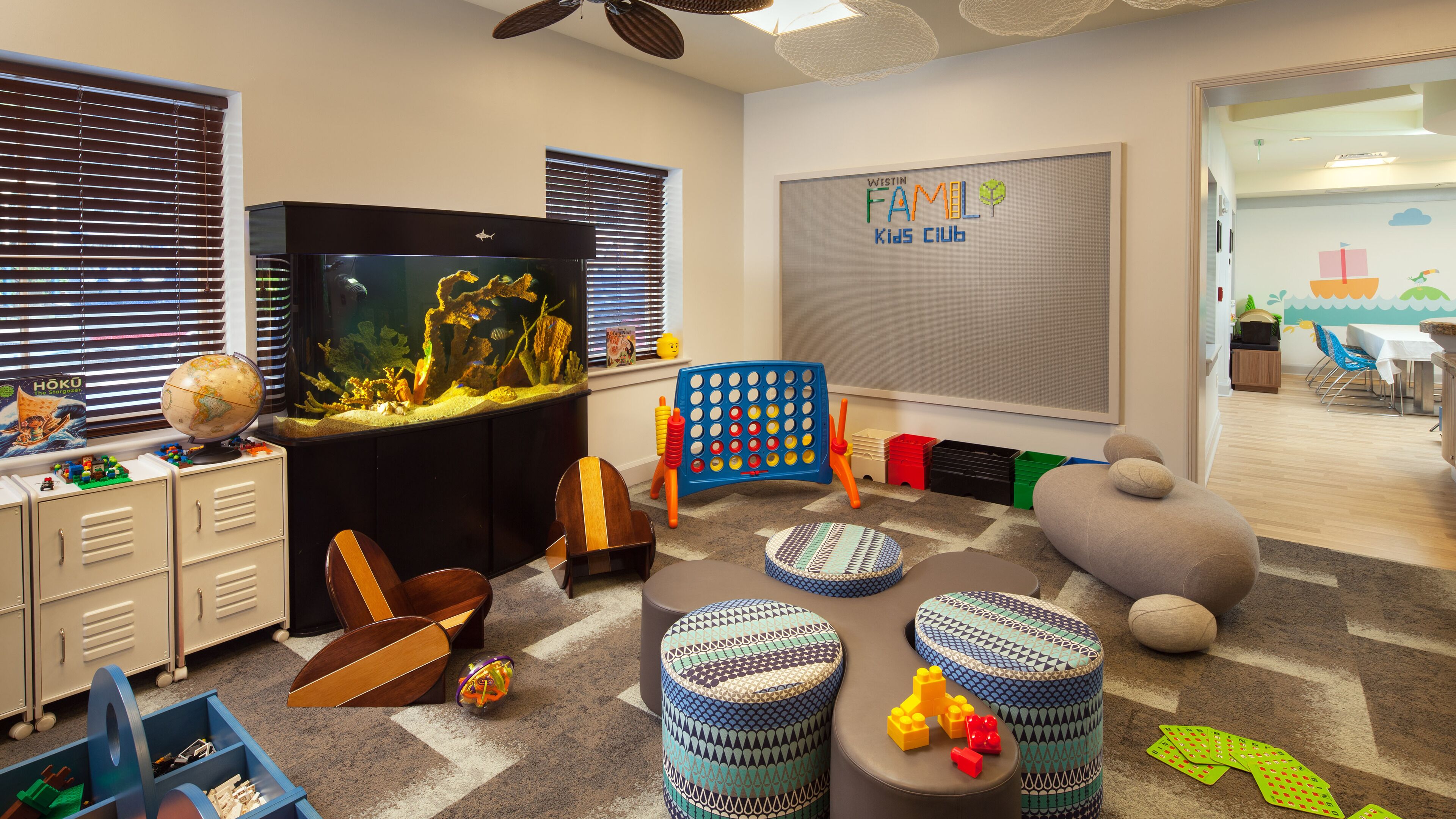 A children's play area with a globe, an aquarium, and various toys.