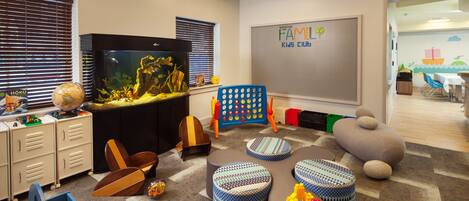 A children's play area with a globe, an aquarium, and various toys.