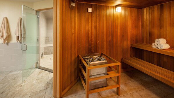 A sauna room with wooden walls, a glass shower enclosure, and a bench with towels. - Oceanfront - Studio - Westin Kaanapali Ocean Resort Villas - Full Resort Access (Lahaina)