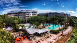 A resort with a swimming pool, lounge areas, and multiple hotel buildings.