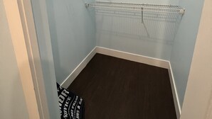 A walk-in closet with metal shelving units and a dark floor. - Spacious upper-level unit located on Main St. (Vancouver)