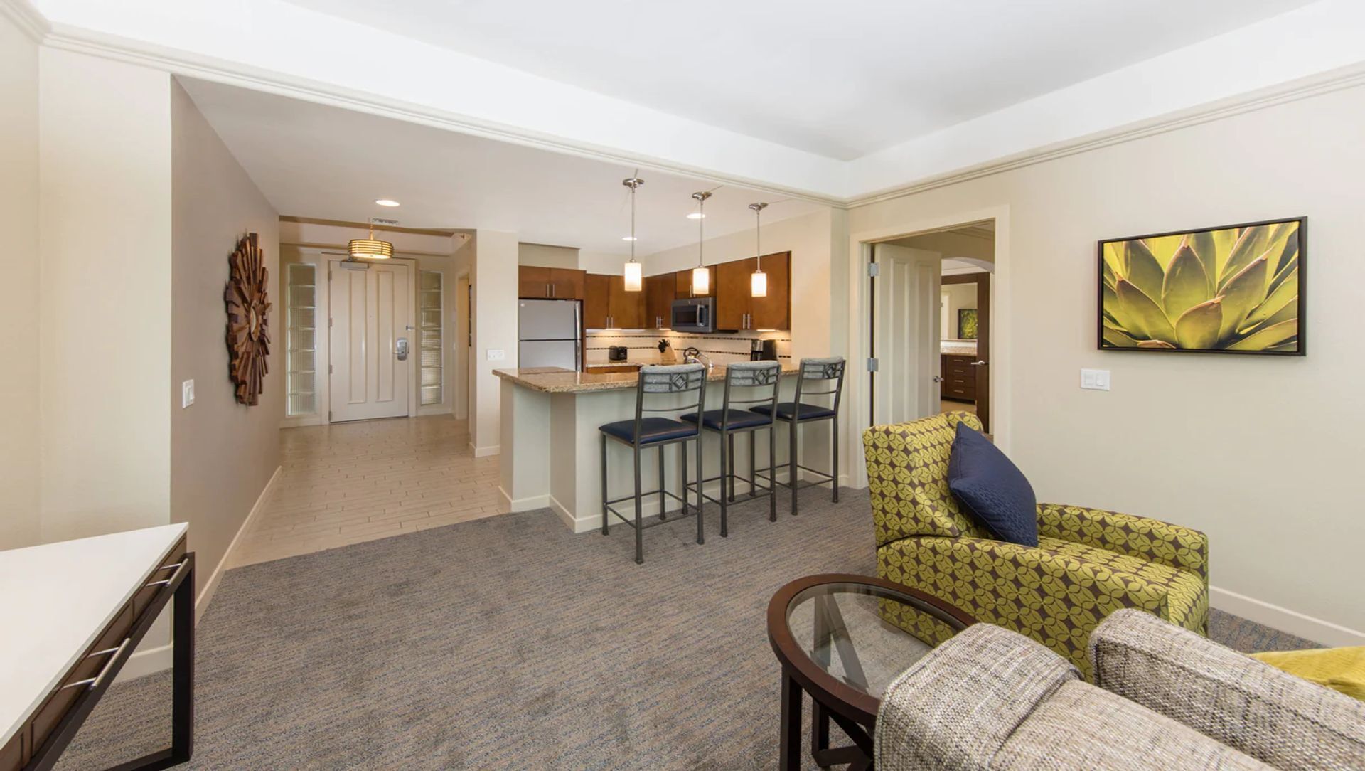 A modern apartment with a kitchen, dining area, and living room.