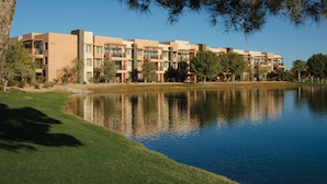 A modern hotel with multiple buildings, a reflective water body, and well-maintained greenery. - Studio - Marriott's Shadow Ridge II - The Enclaves - Full Resort Access (Palm Desert)