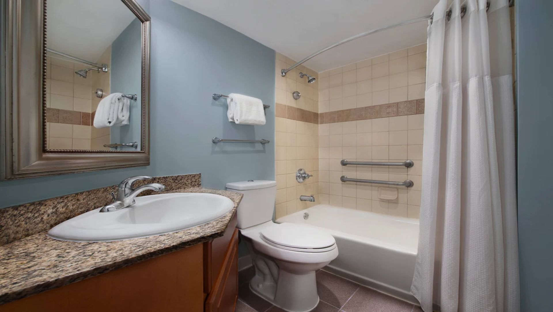 A bathroom with a sink, toilet, and bathtub.