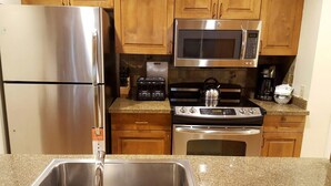 A kitchen with stainless steel appliances, including a refrigerator, microwave, toaster, stove, and sink. - Studio - Marriott's StreamSide at Vail - Birch, Douglas, and Evergreen - Full Resort Access (Vail)