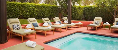 A poolside area with lounge chairs and a swimming pool.