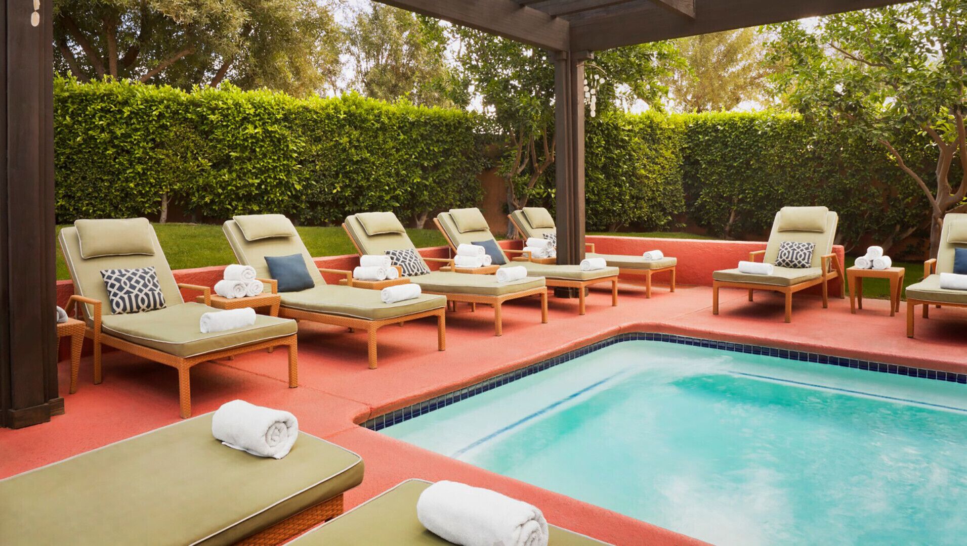 A poolside area with lounge chairs and a swimming pool.
