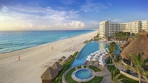 A resort with a beachfront, a pool, and a hotel building. - 1 Bedroom - Westin Lagunamar Ocean Resort - Full Resort Access (Cancún)