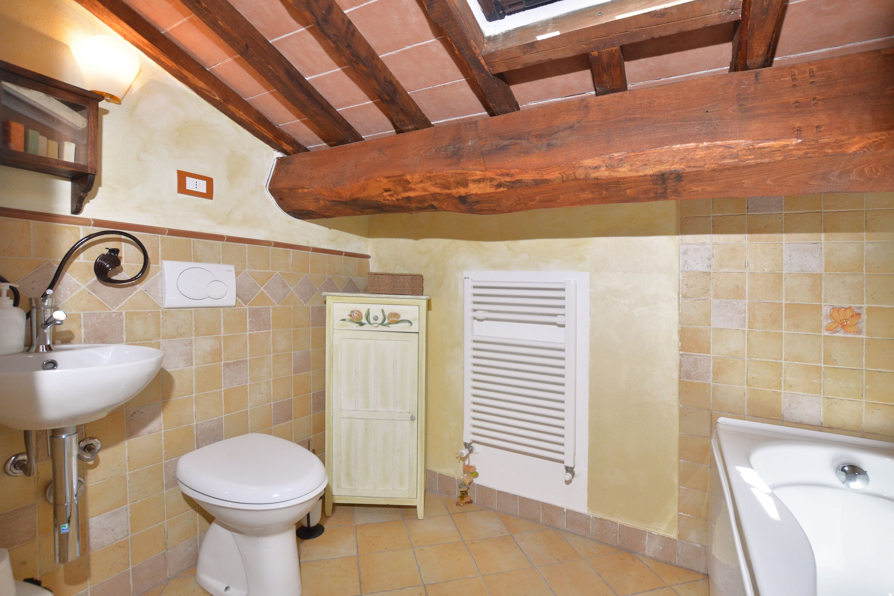 A bathroom with a sink, toilet, and bathtub.