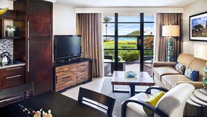 A modern living room with a flat-screen TV, wooden cabinets, a dining area, and a sofa. - 2 Bedroom Villa - Westin St. John Coral Vista Villas - Full Resort Access (St. John)
