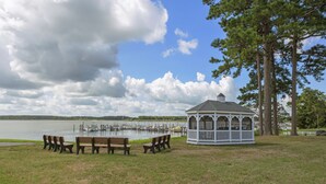 A gazebo with a view of a lake and dock, surrounded by benches and trees. - Spacious Home to Create Memories - access to Bay river and beaches (Millsboro)