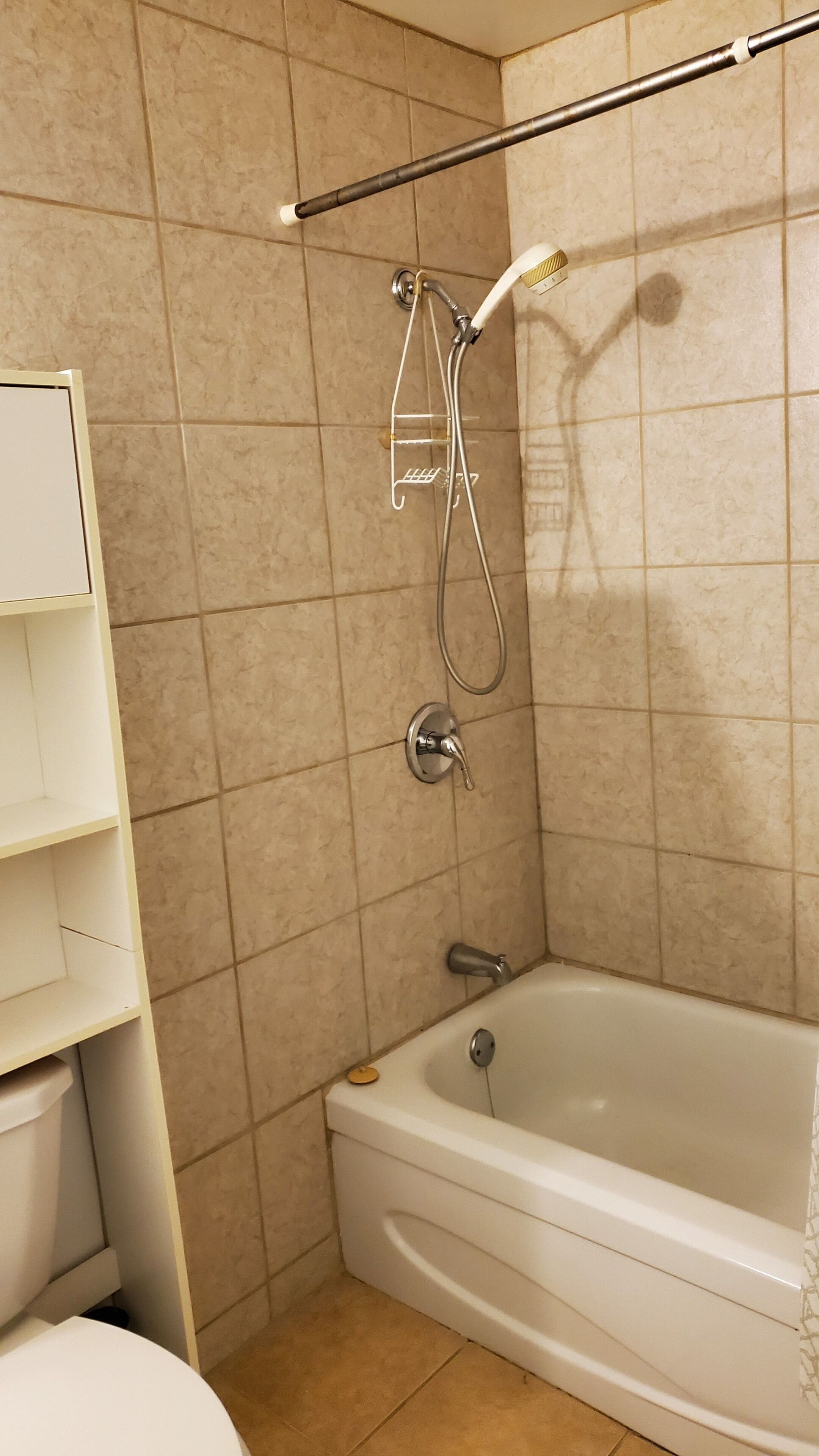 A bathroom with a bathtub, a shower, and a toilet.
