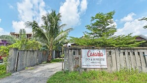 A sign for Casaria Inn & Homestay with a contact number and mentions Casa Group Hospitality Management. - OYO HOME 90646 Casaria Paka Homestay (Dungun)