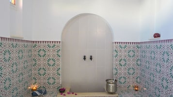 Bathroom features a unique tile pattern and a curved ceiling.