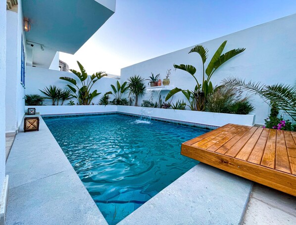 Outdoor pool, open 9:00 AM to 9:00 PM, sun loungers