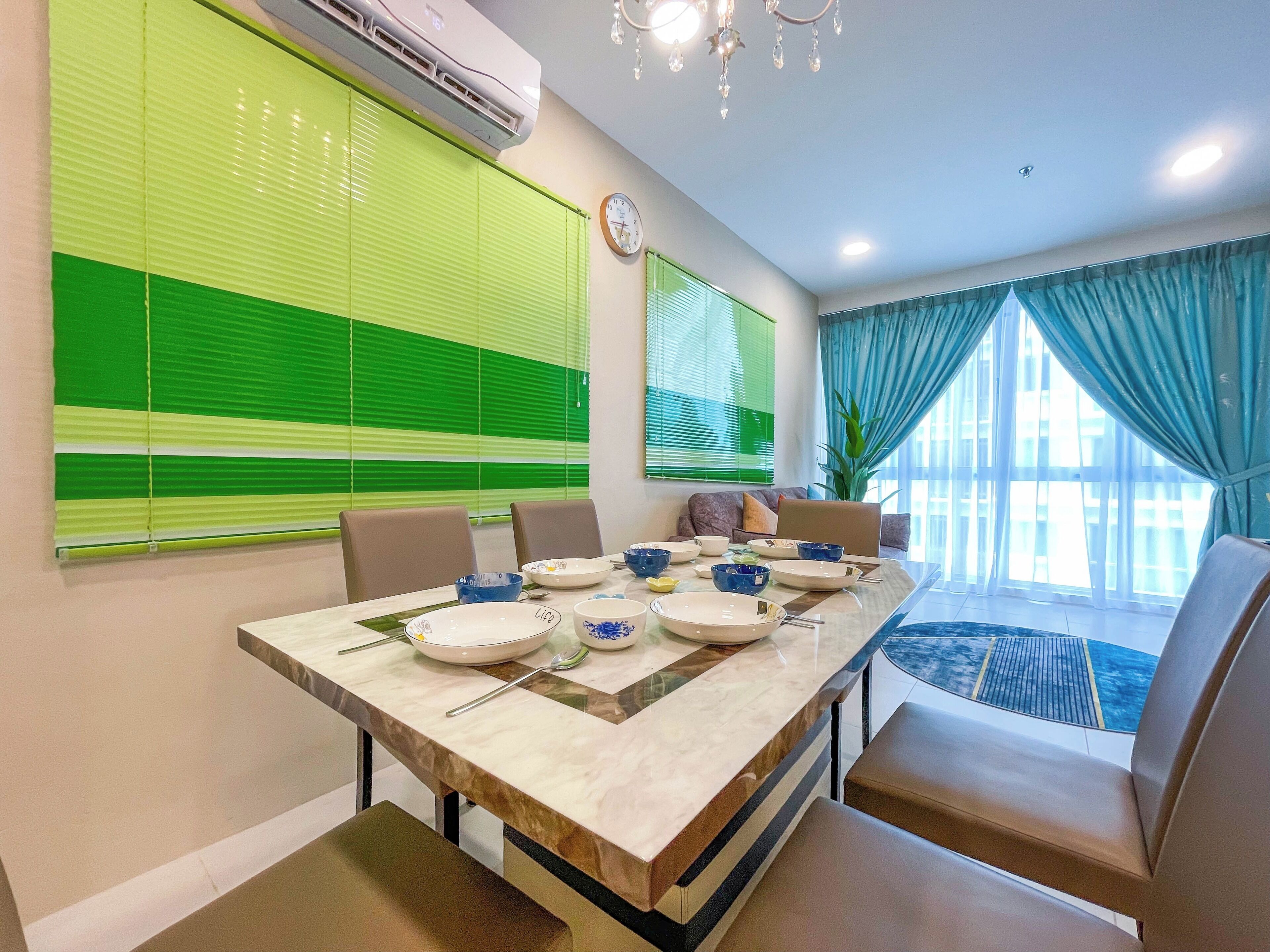A dining area with a marble table, chairs, and a clock on the wall.