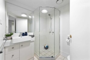 Combined shower/bathtub, towels, soap, toilet paper