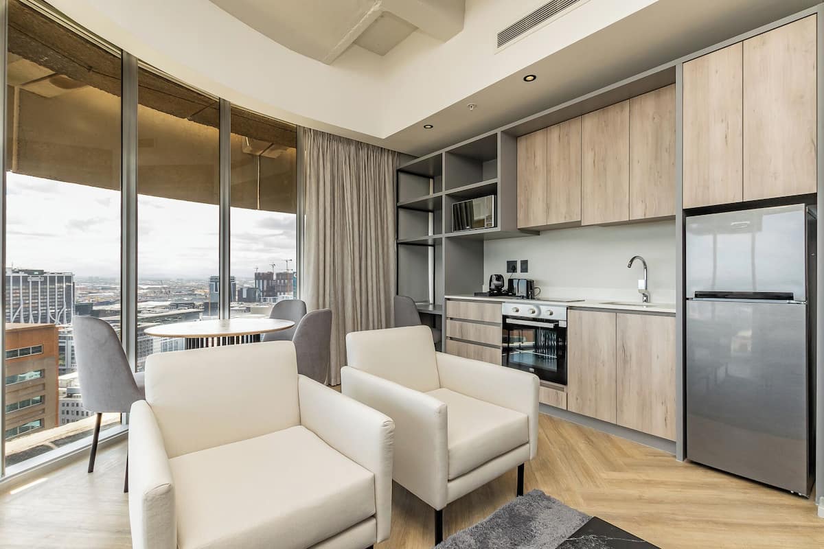 A modern apartment with a kitchen, dining area, and seating space.