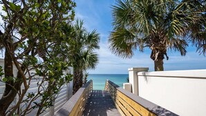 A wooden pathway leading to a beach with palm trees and a clear view of the ocean. - L'escapade, Old Seagrove, Near Seaside, Private Heated Pool, Close to Beach (Seagrove Beach)