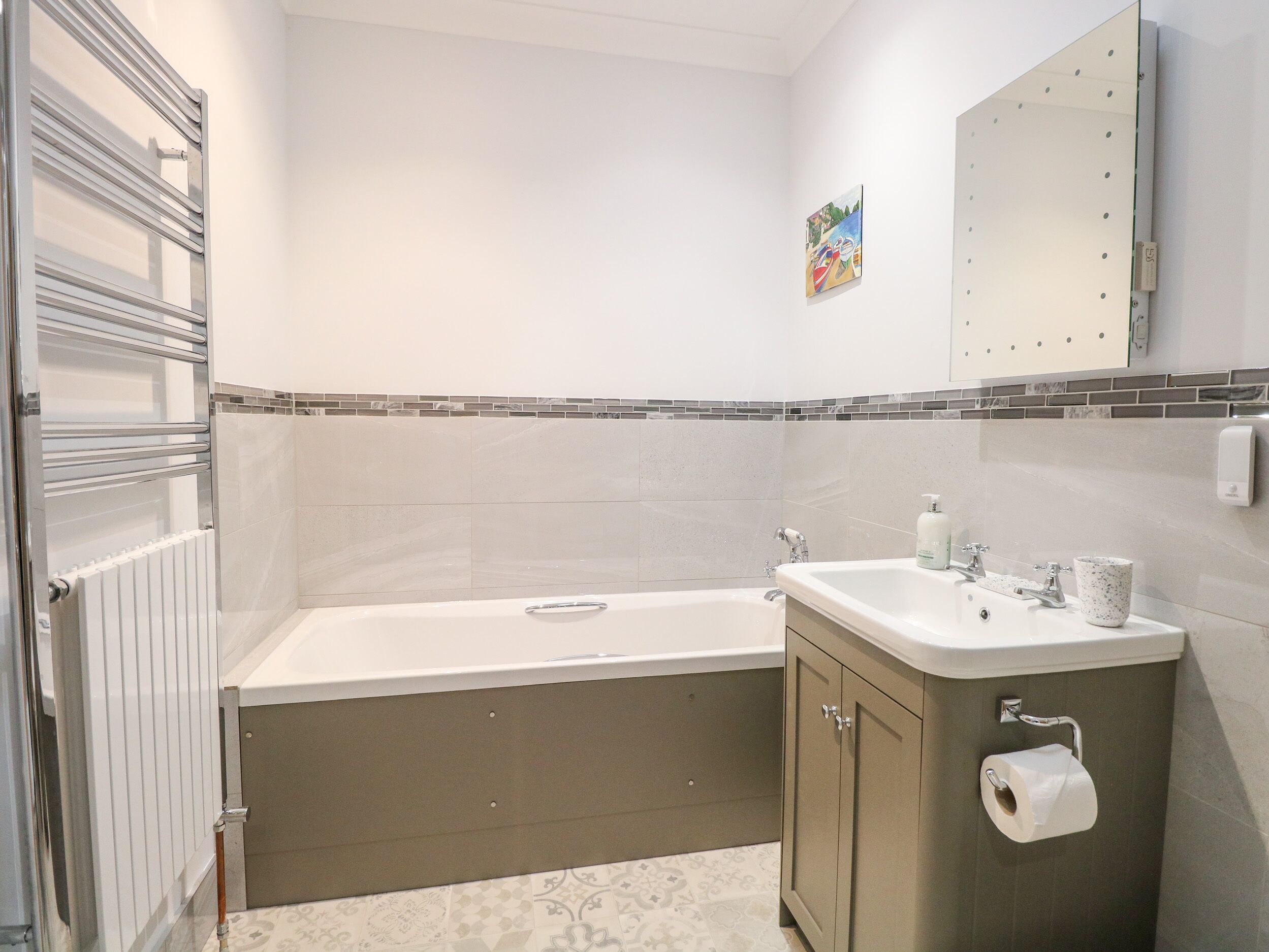 A modern bathroom with a bathtub, a sink, and a toilet.