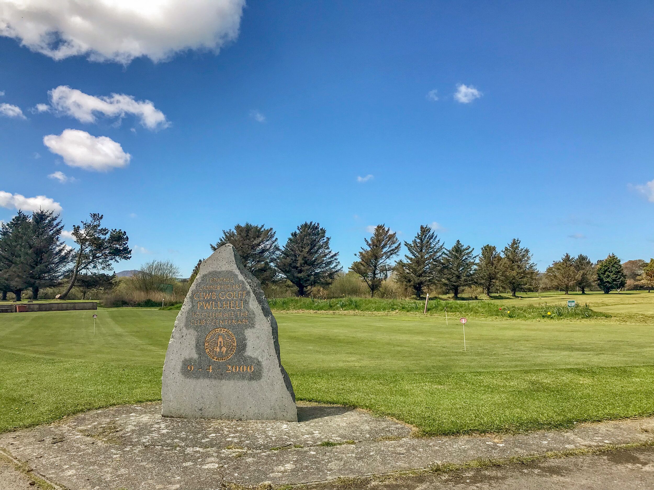 A golf course with a commemorative monument.