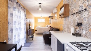 A compact kitchen with a gas stove, a sink, and a wooden cabinet. - Las Latas del Almendro 1 (Santiago del Teide)