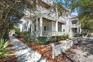 A two-story house with a porch, surrounded by trees and a pathway. - 30A Retreat-Beach Access Nearby-Comm Pools-4 Bikes (Santa Rosa Beach)