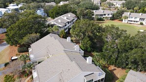 A residential area with multiple houses, some with attached garages and others with detached garages.