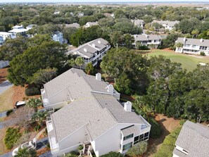 A residential area with multiple houses, some with attached garages and others with detached garages. - Wild Dunes near beach villa, community pool, tennis court, screened porch! (Isle of Palms)