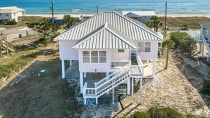 A two-story beach house with a balcony, a covered porch, and a view of the ocean. - Welcome to Gulf Dreams! (St. George Island)