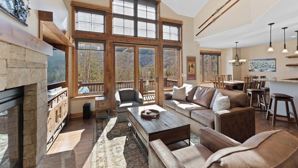 A spacious living room with a fireplace, large windows, and a cozy seating area. - Half-Mile to Keystone Base Area! Incredible Slope Views, Private Hot Tub (Keystone)