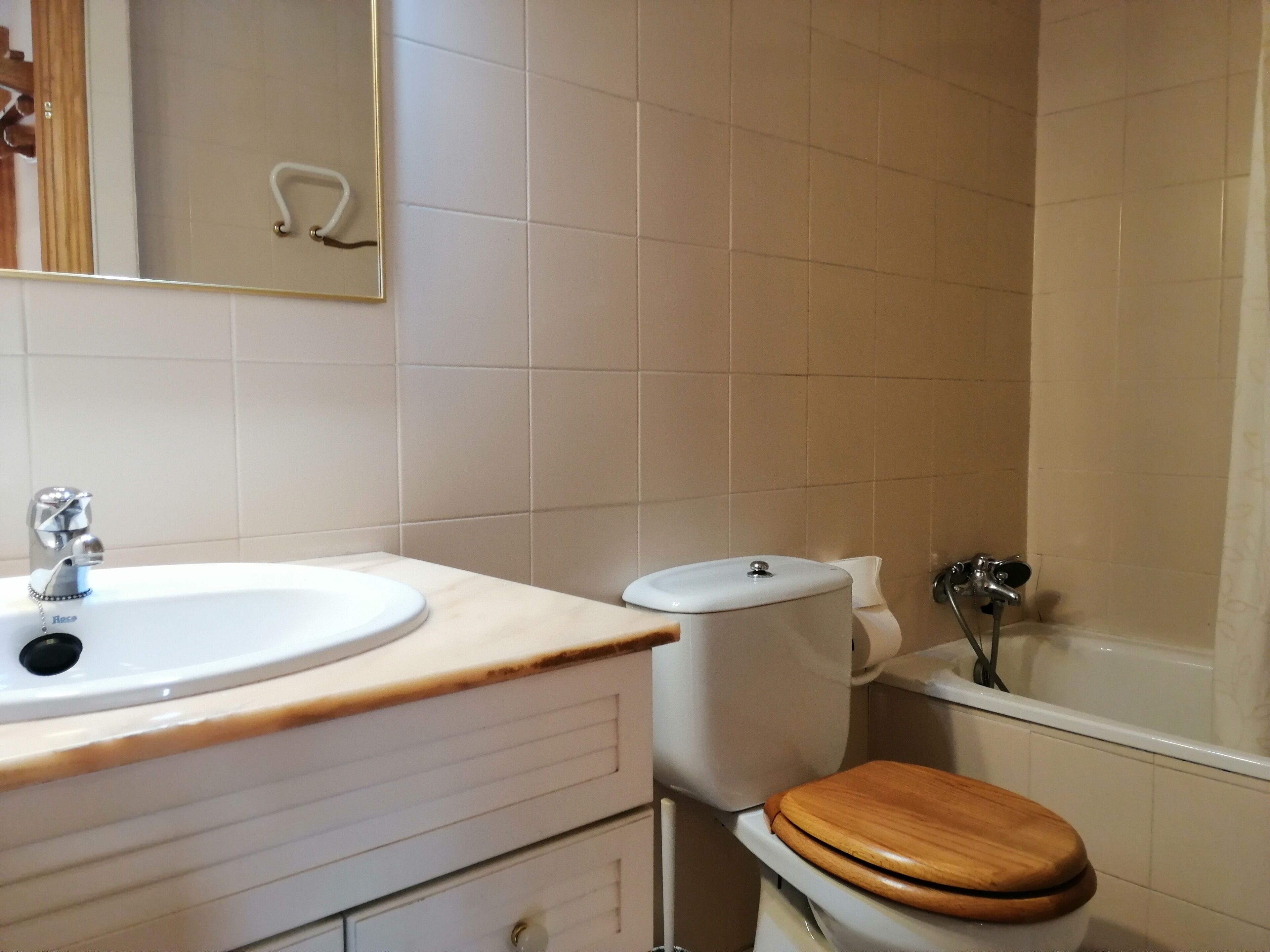 A bathroom with a sink, toilet, and bathtub.