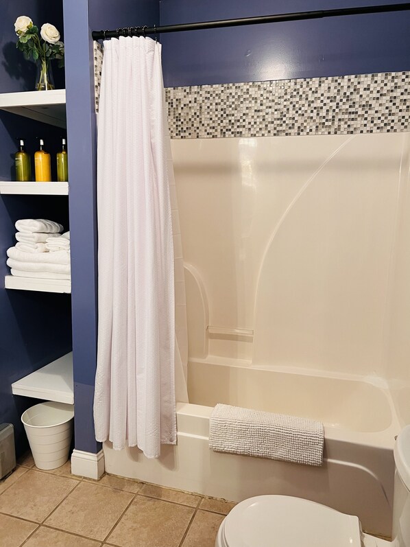 Combined shower/tub, hair dryer, towels, soap