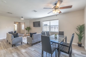 Relax in this stylish living space with a dining area, sofa, and flat-screen TV.
