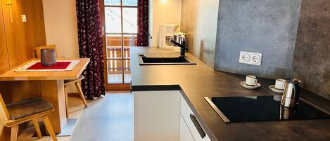 Fridge, stovetop, dishwasher, coffee/tea maker