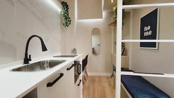 Estudio Cama Elevada com Escada | Desk, laptop workspace, blackout curtains, iron/ironing board