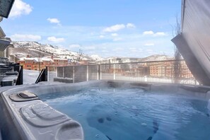 A hot tub with a view of snow-covered hills and buildings. - Canyons Ridge - Brand New Ski In Townhouse (Park City)
