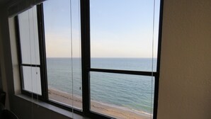 A room with a large window overlooking a beach. - Oceanfront dream condo 2/2 (Hollywood)