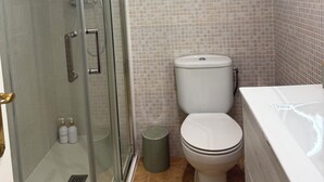 A bathroom with a glass-enclosed shower, a toilet, and a bathtub. - MODERN APARTMENT IN THE CENTER OF MARBELLA (Marbella)