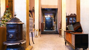A hotel lobby with a Christmas tree, a vintage stove, and a piano. - Mala Vecindad Centro Historico (Mexico City)