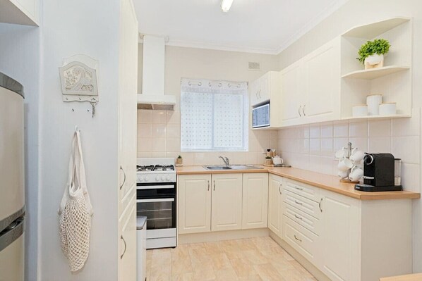 Fridge, microwave, stovetop, coffee/tea maker