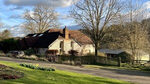 A rural house with a sloped roof, a chimney, and a fenced yard. - Luxury Chilterns Hideaway, Easy Access to London (Reading)