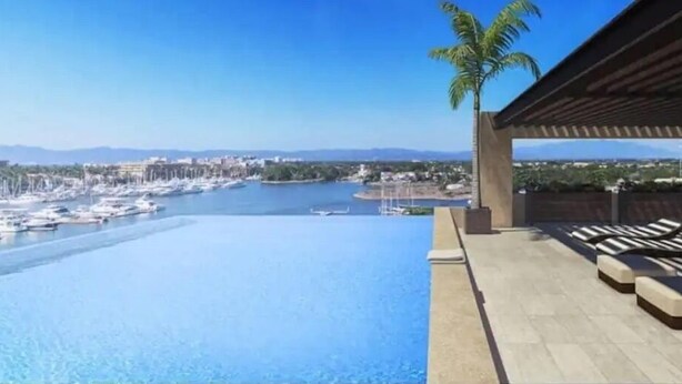 A poolside area with a view of a marina and distant mountains. - FRACCIONAMIENTO NAUTICO by TRVL2HM (Nuevo Nayarit)