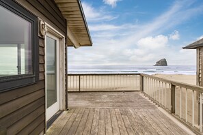Enjoy the ocean view from this deck overlooking a sandy beach.
