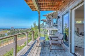 Relax on the spacious balcony with ocean views and enjoy the scenic coastal landscape from the comfort of your seating area.