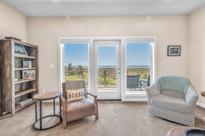 Relax in a comfortable seating area with a scenic view from the balcony through the large sliding glass door.